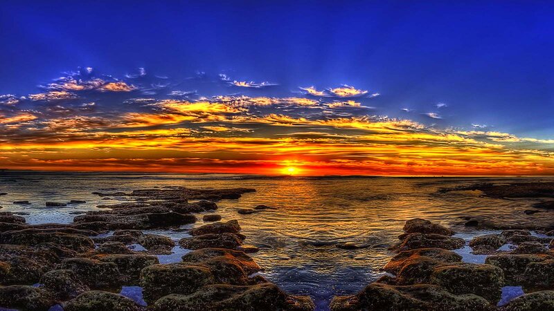 Sunset over Rocky Shore — Blue, Dramatic, Photograph, Ocean, Clouds