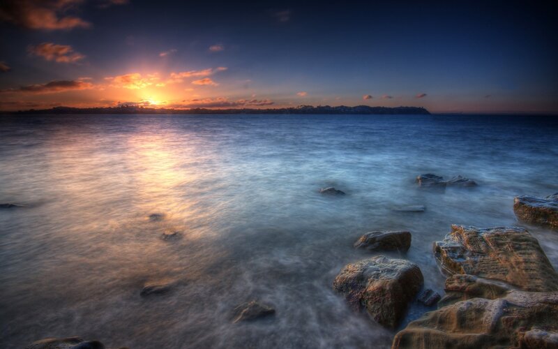 Sunset over Rocky Shore — Blue, Serene, Photograph, Rocks, Sea