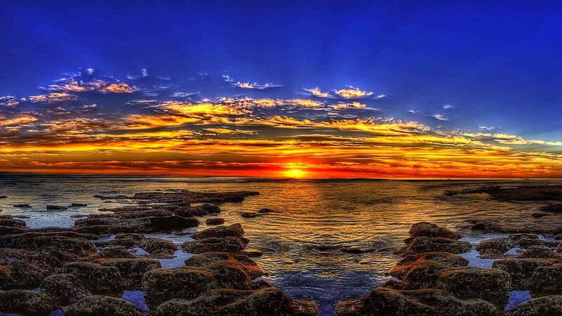 Sunset over Rocky Shore — Blue