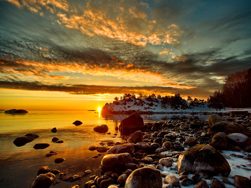 Sunset over Rocky Shore — Orange, Dramatic, Photograph, Sun, Rocks, Snow