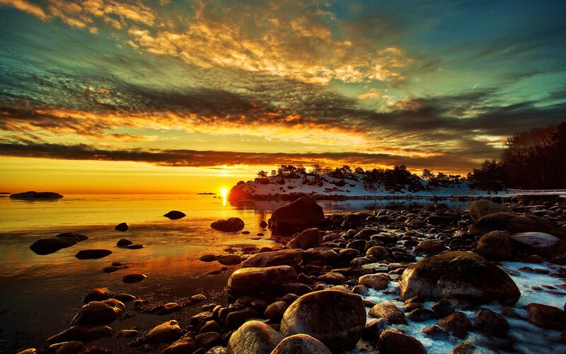 Sunset over Rocky Shore — Orange, Dramatic, Photograph, Sun, Rocks, Snow, Trees
