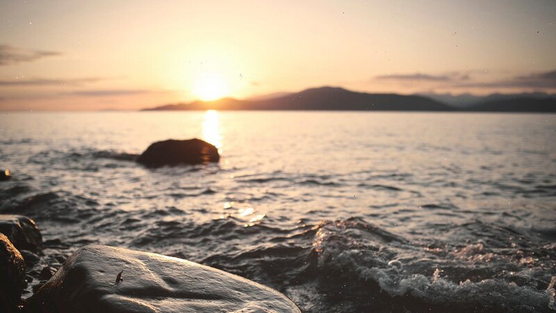 Sunset over Rocky Shore — Orange, Serene, Photograph, Sea, Mountains, Rocks