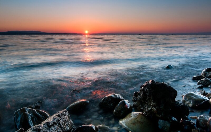 Sunset over Rocky Shore — Orange, Serene, Photograph, Sun, Ocean, Rocks, Blue