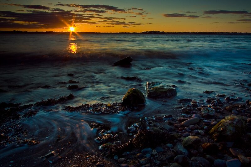 Sunset over Rocky Shore — Orange, Serene, Photograph, Sun, Ocean, Rocks, Clouds, Blue