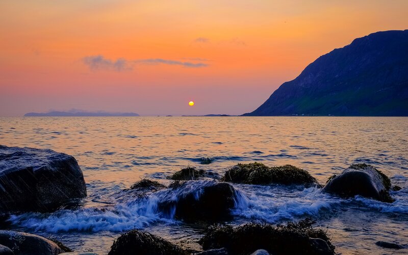 Sunset over Rocky Shore — Orange, Serene, Photograph, Sun, Sea, Mountain