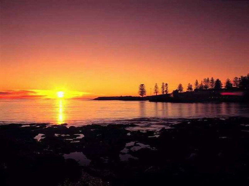 Sunset over Rocky Shore — Orange, Serene, Photograph