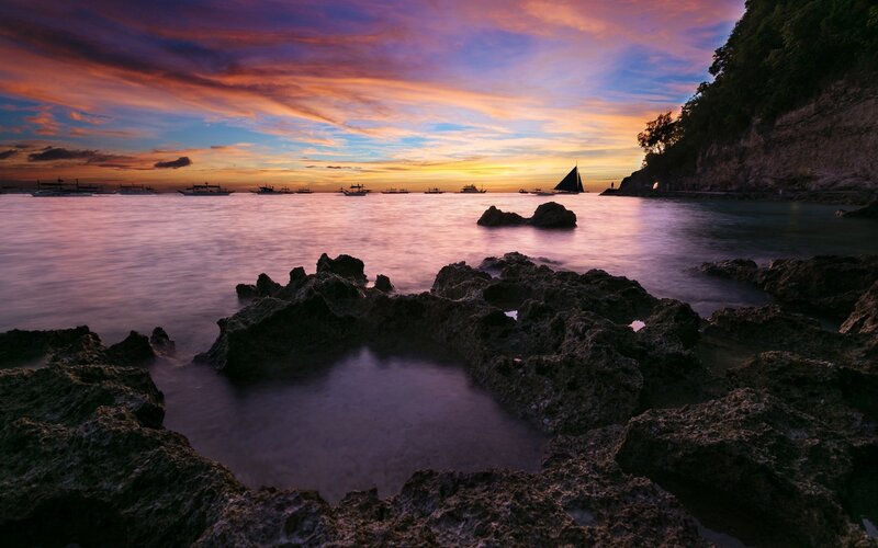 Sunset over Rocky Shore — Purple, Serene, Photograph, Boats