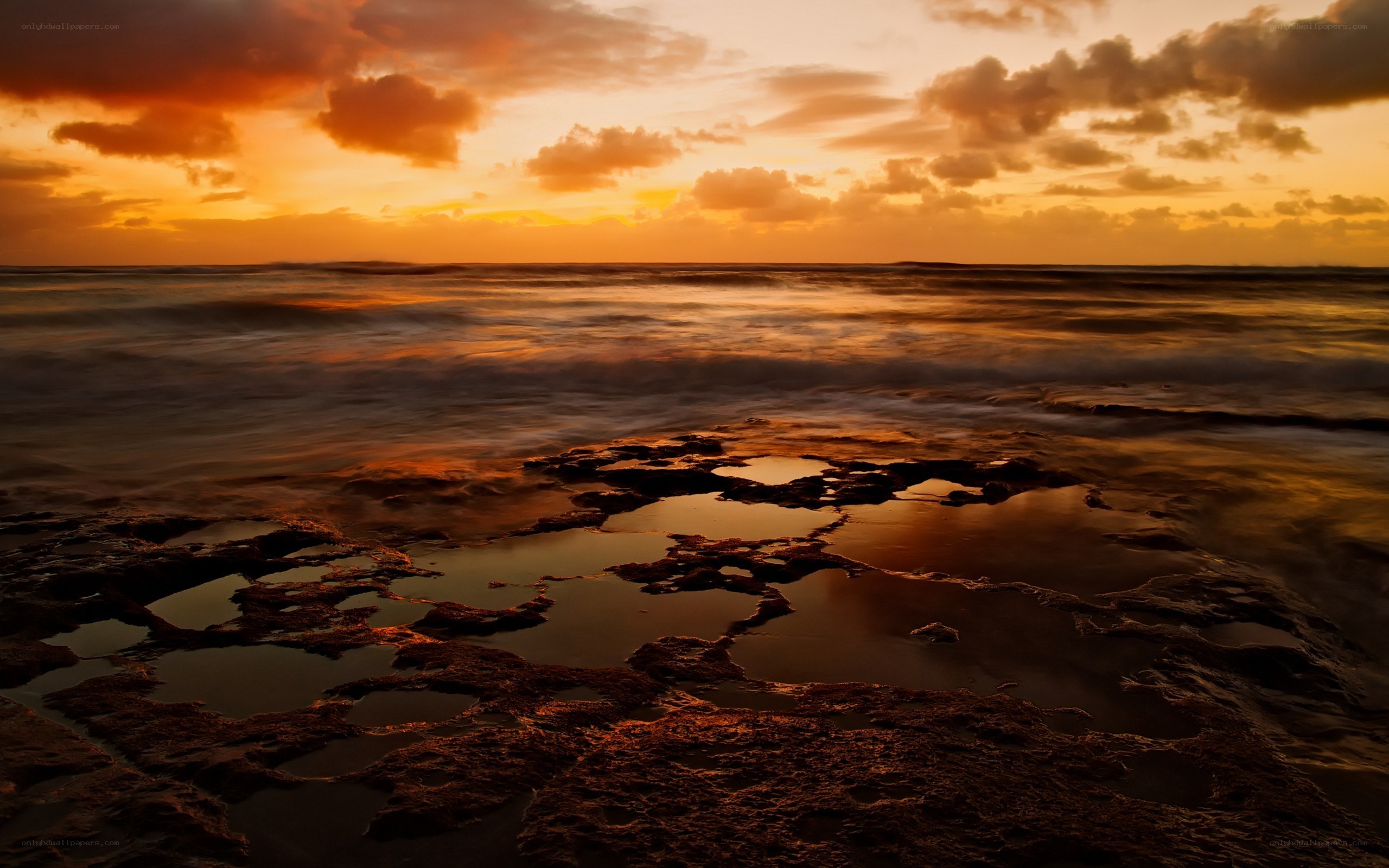 Sunset over rocky shoreline