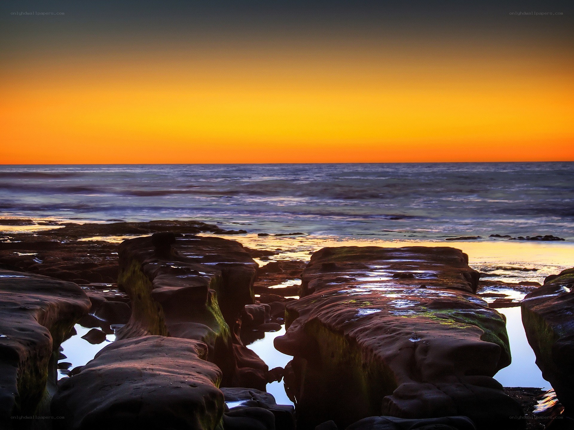 Sunset over rocky shoreline