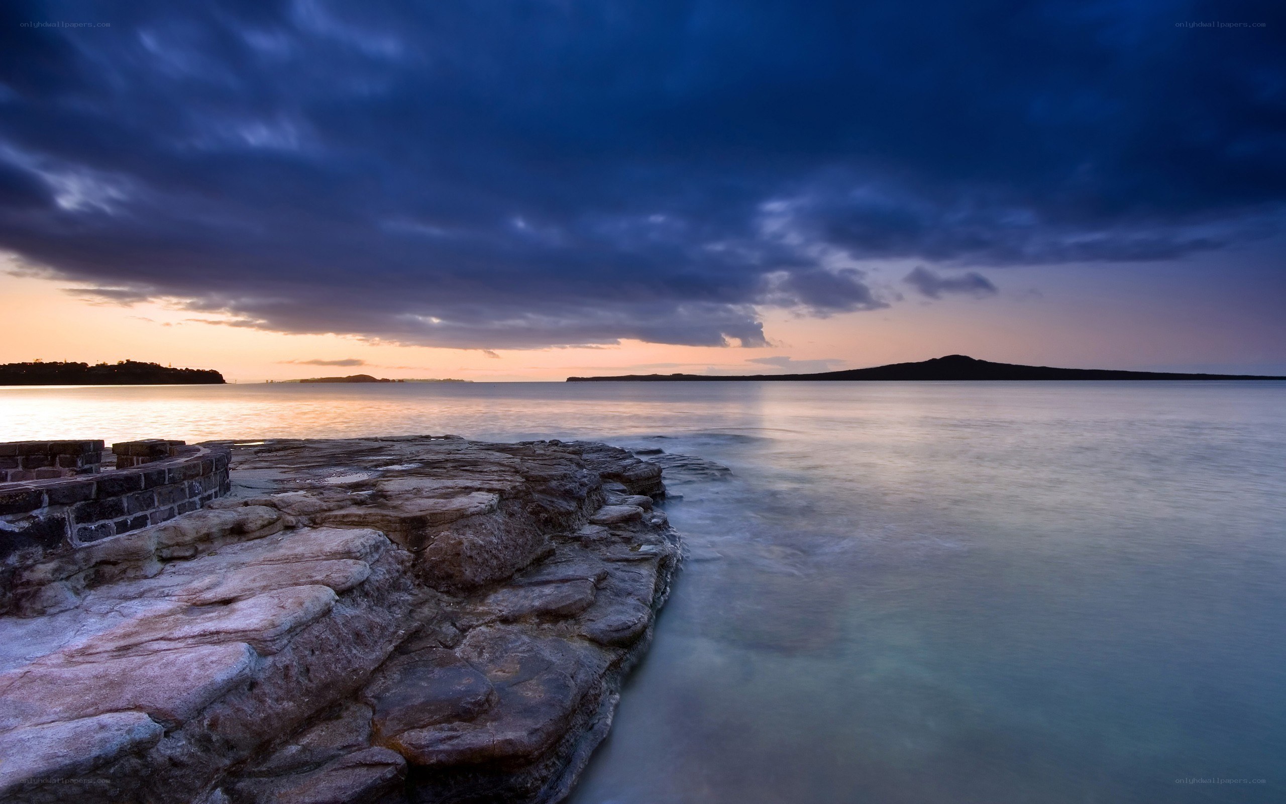 Sunset over rocky shoreline