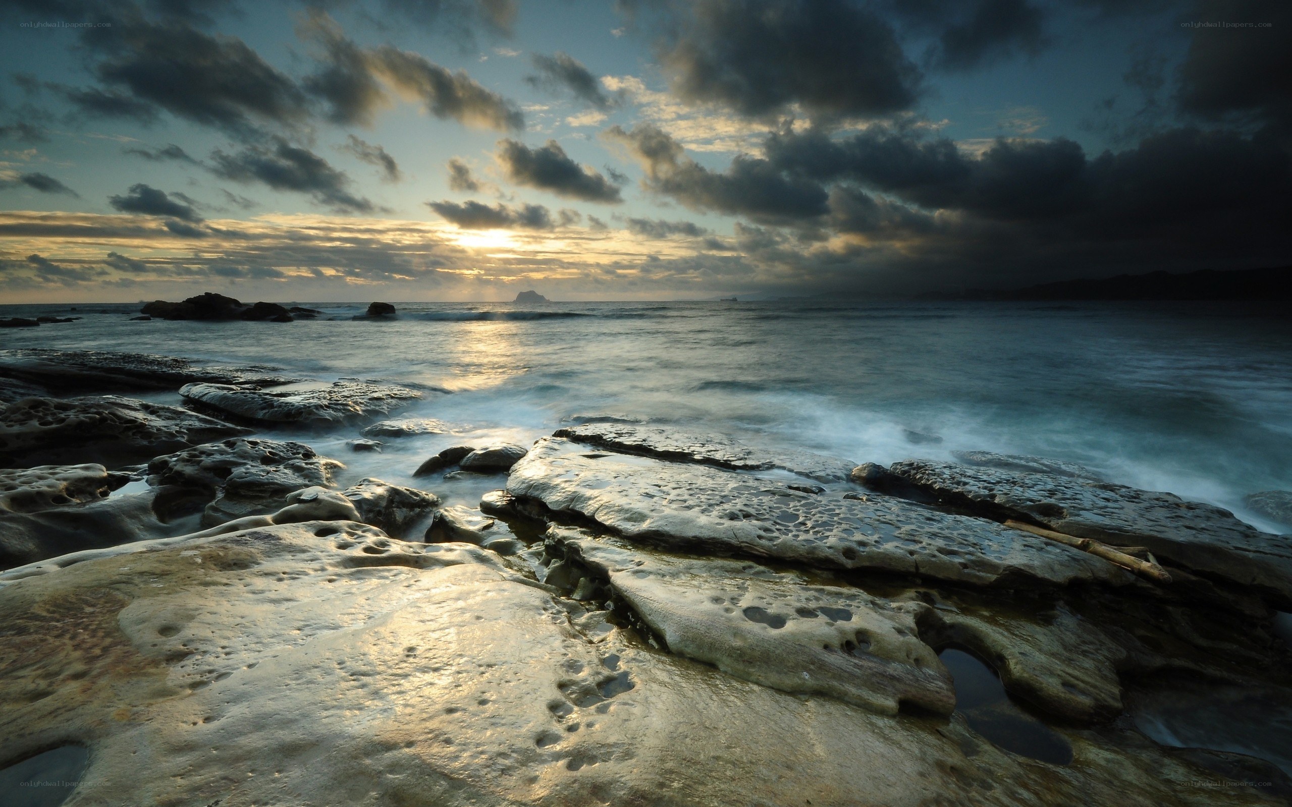 Sunset over rocky shoreline