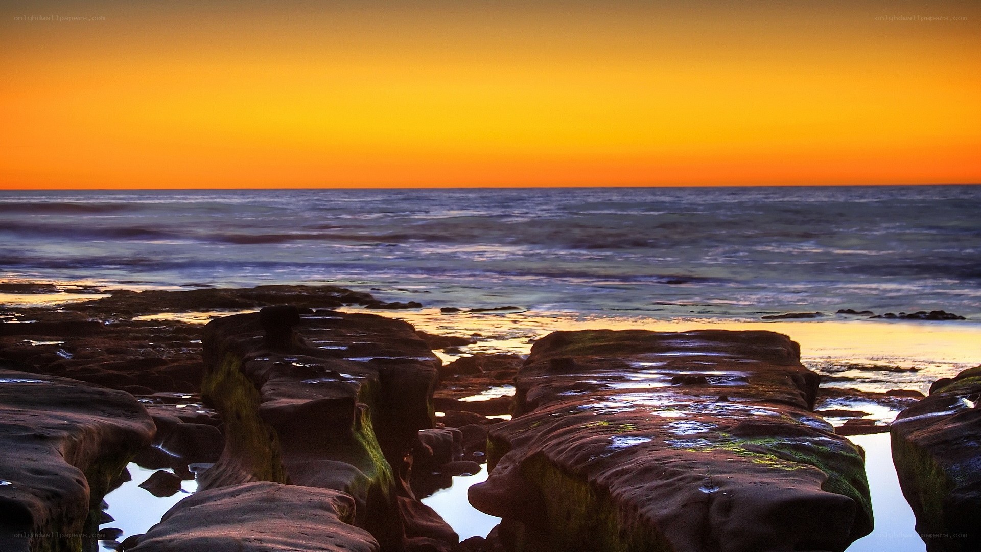 sunset over rocky shoreline