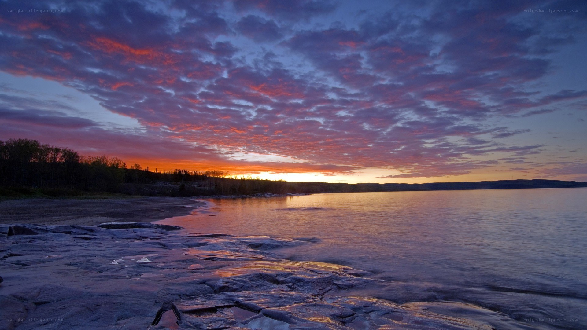 sunset over rocky shoreline