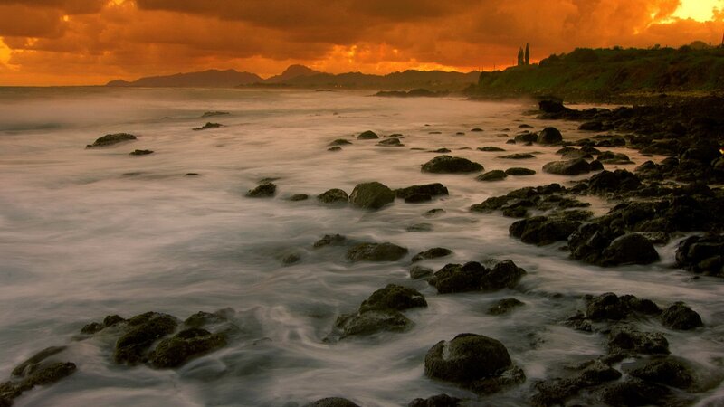 Sunset over rocky shoreline