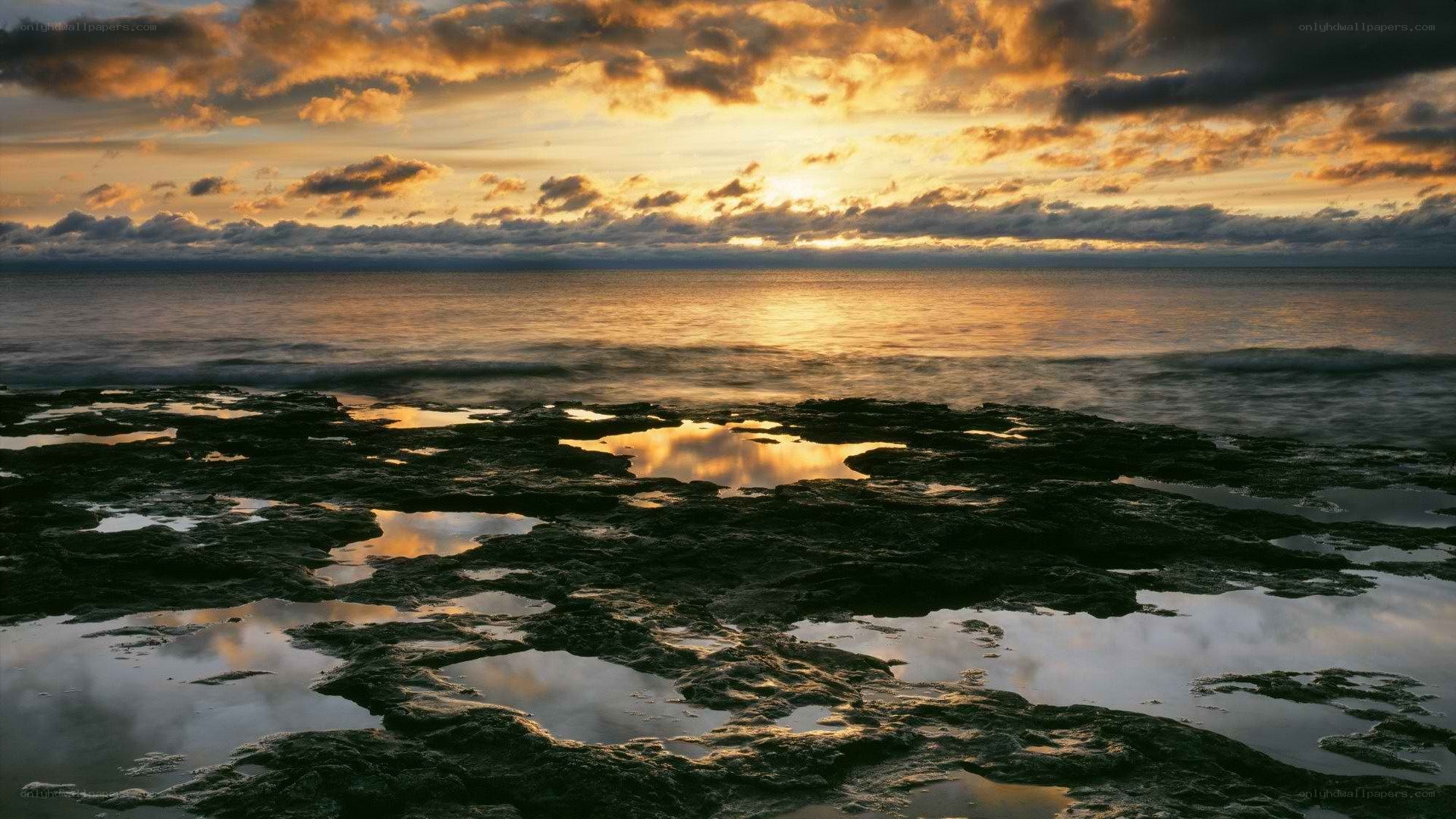 Sunset over rocky shoreline