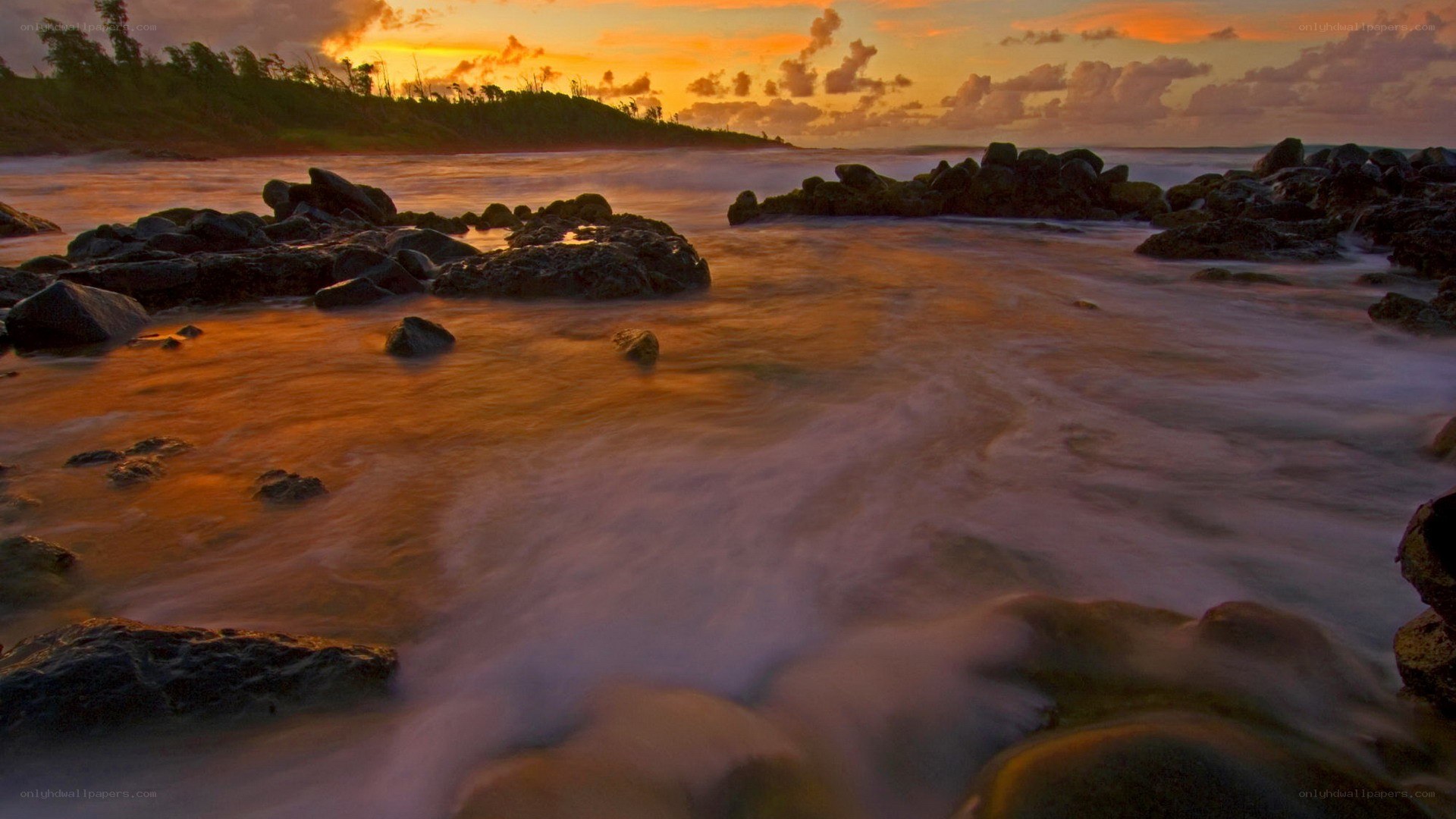 Sunset over rocky shoreline