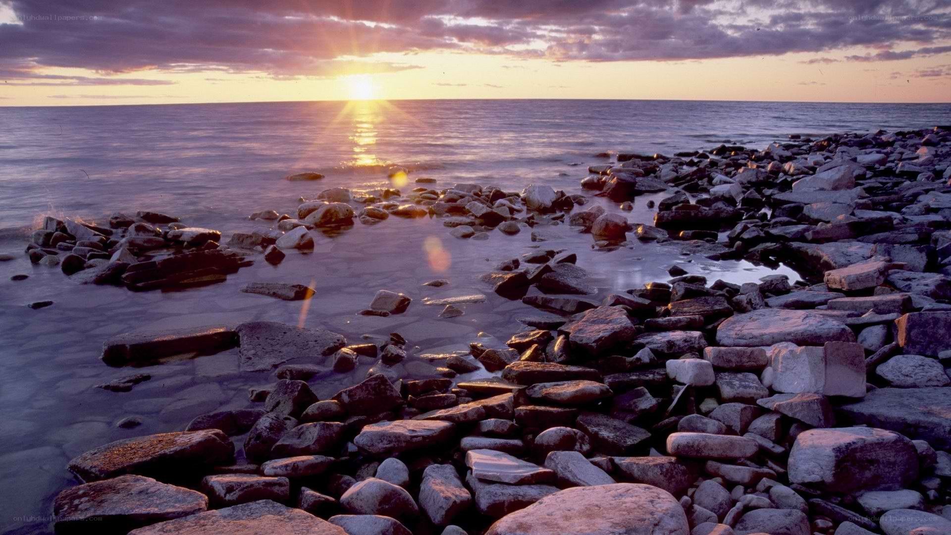 Sunset over rocky shoreline