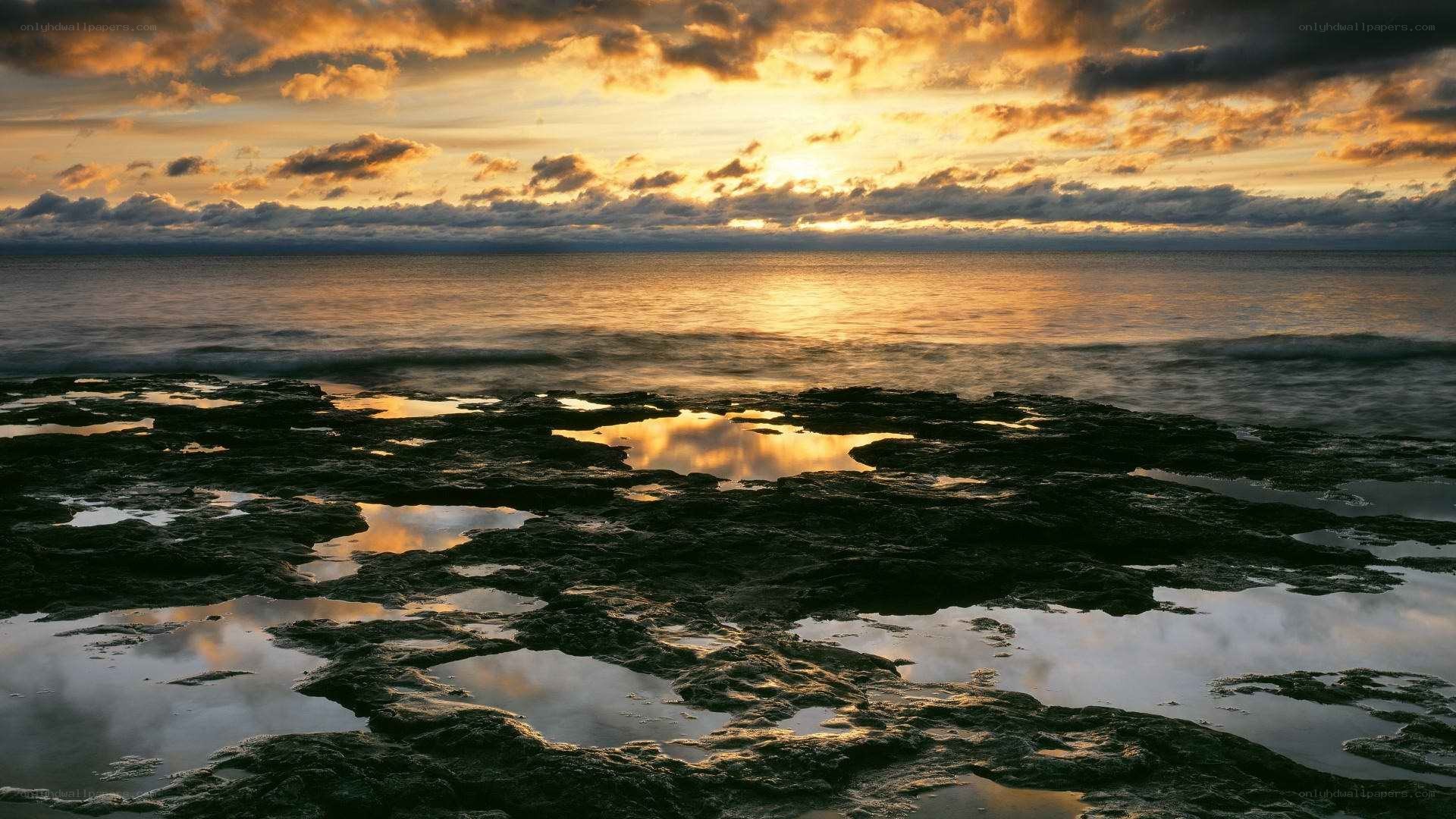 Sunset over rocky shoreline