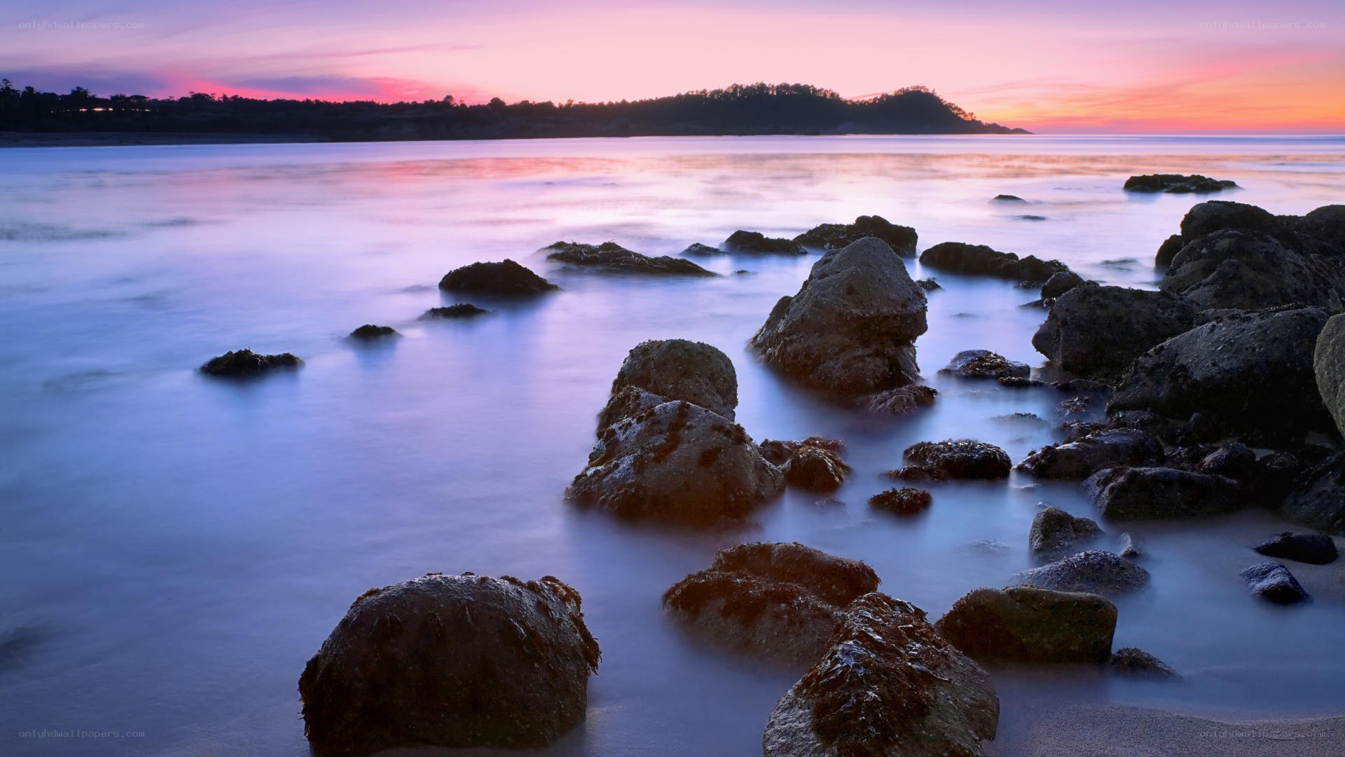 Sunset over rocky shoreline