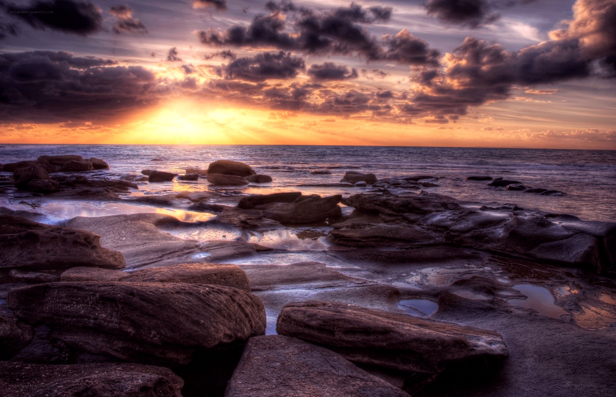 Sunset over rocky shoreline