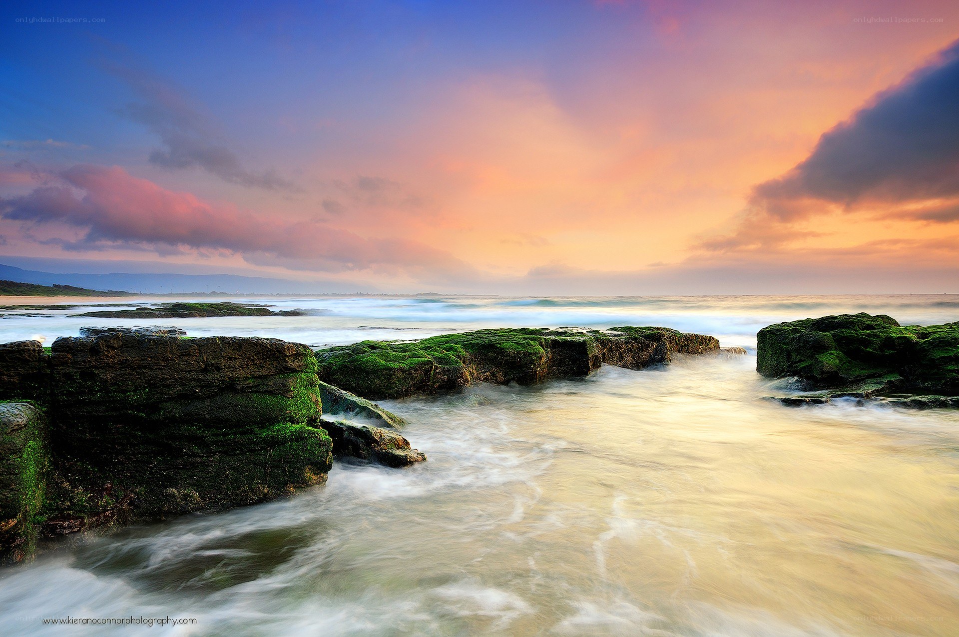 Sunset over rocky shoreline