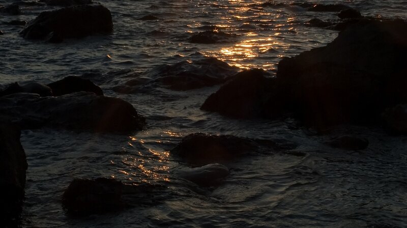 sunset over rocky shoreline