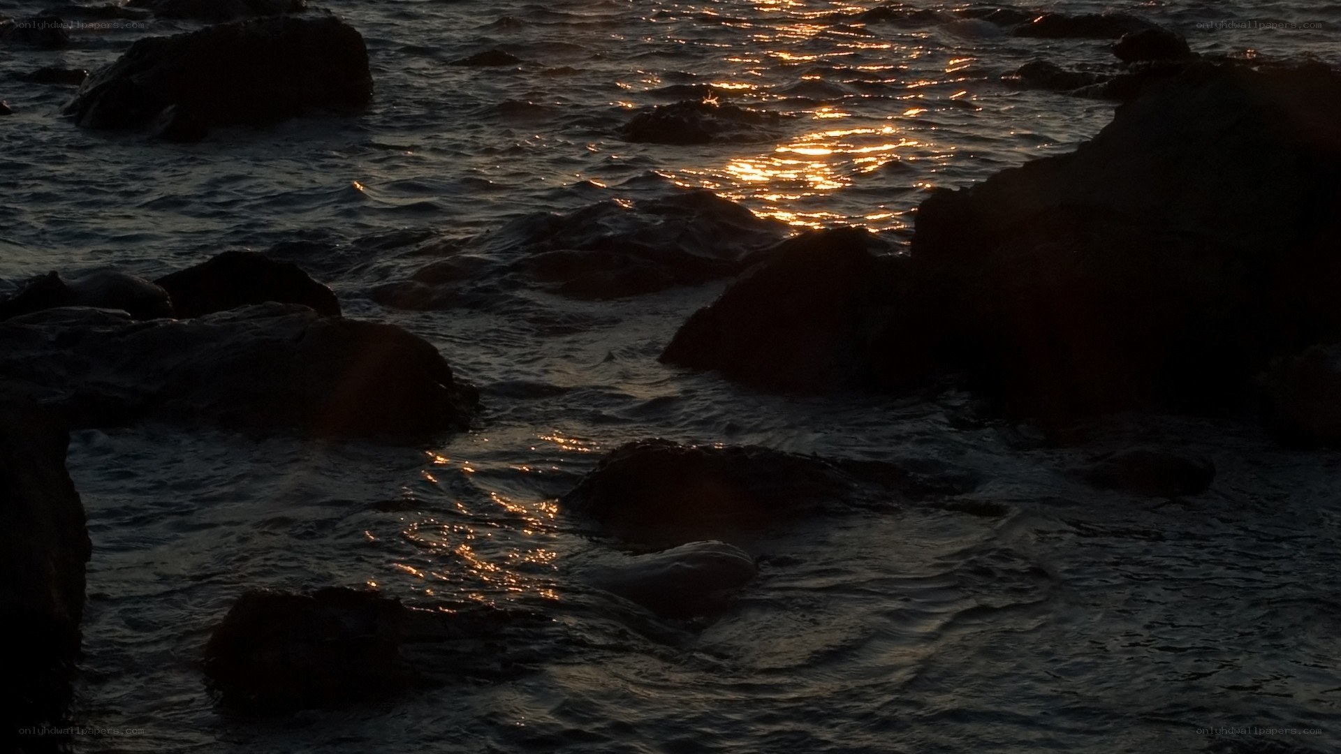 sunset over rocky shoreline