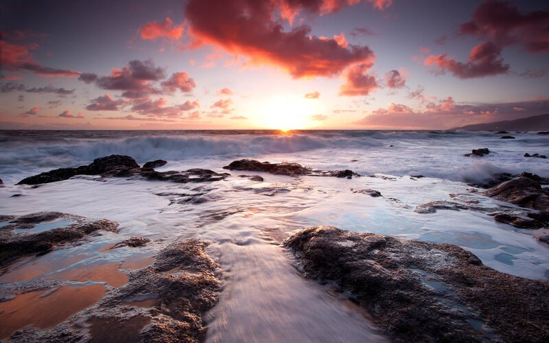 Sunset over rocky shoreline