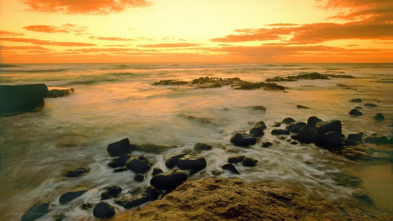 Sunset over rocky shoreline