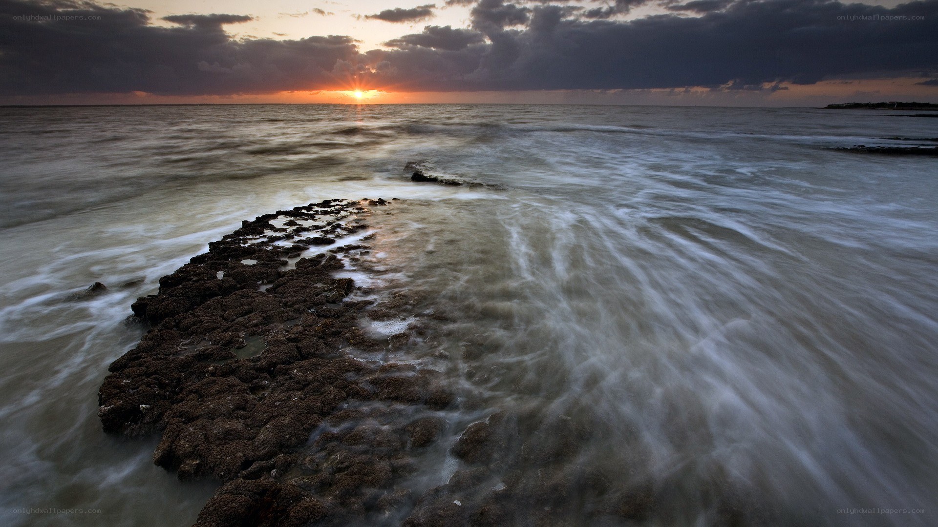 Sunset over rocky shoreline