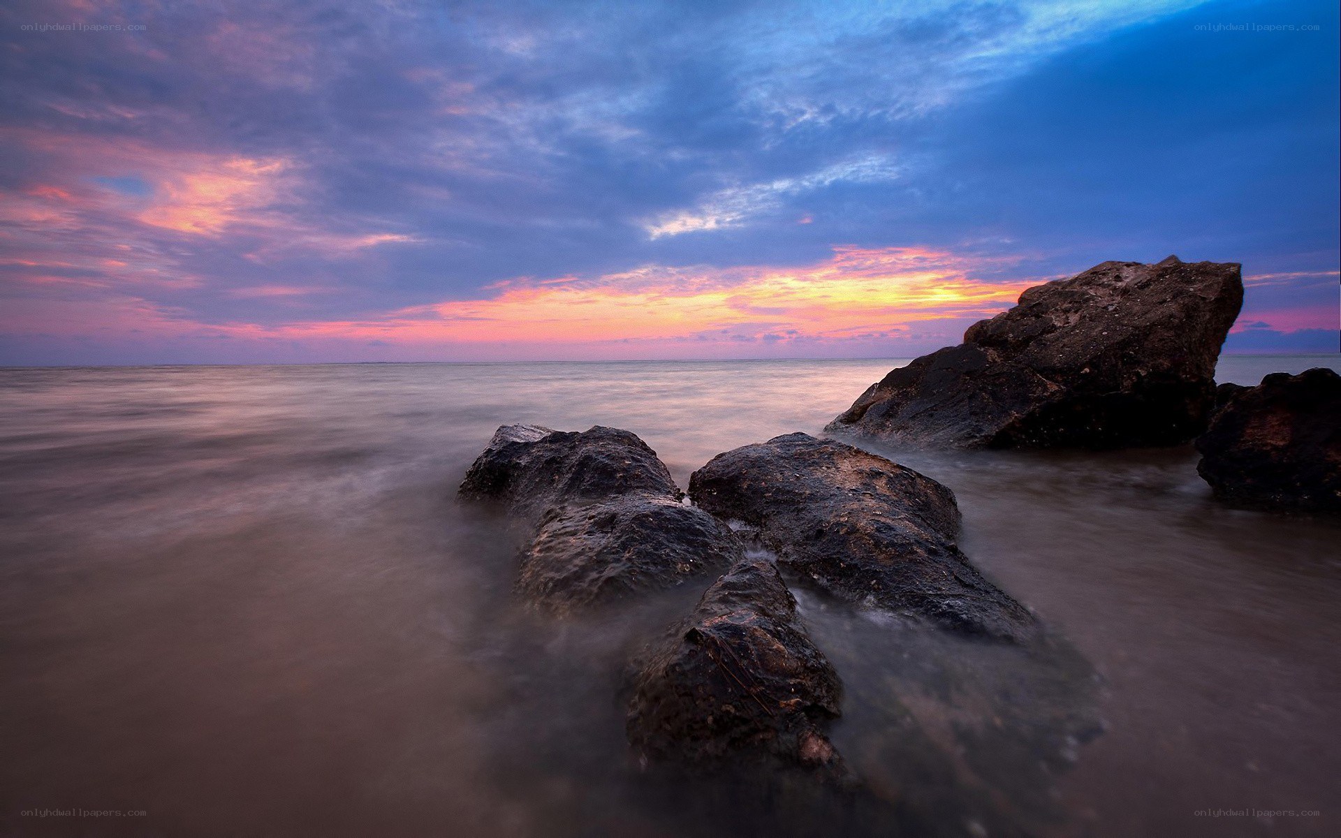 Sunset over rocky shoreline