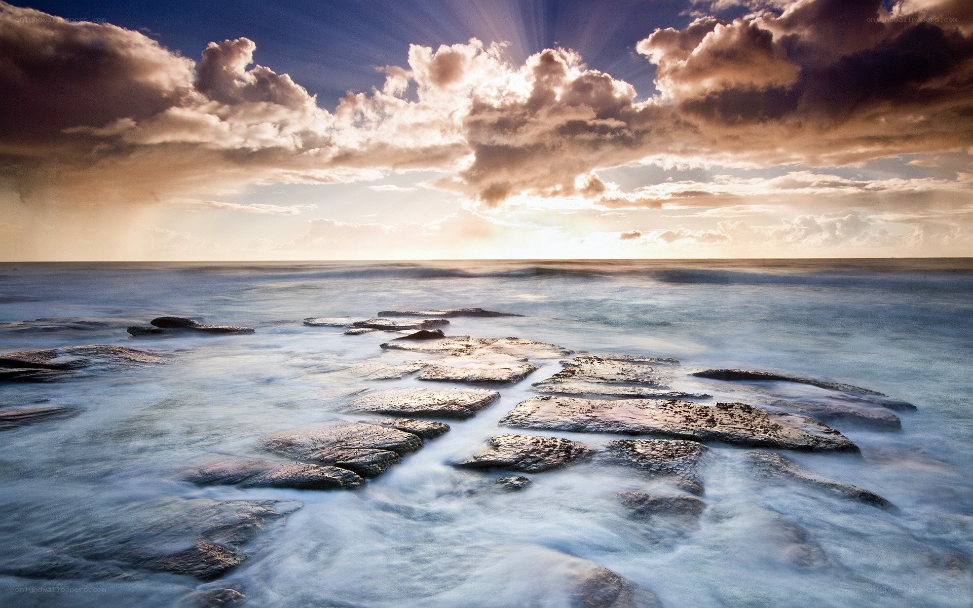 Sunset over rocky shoreline