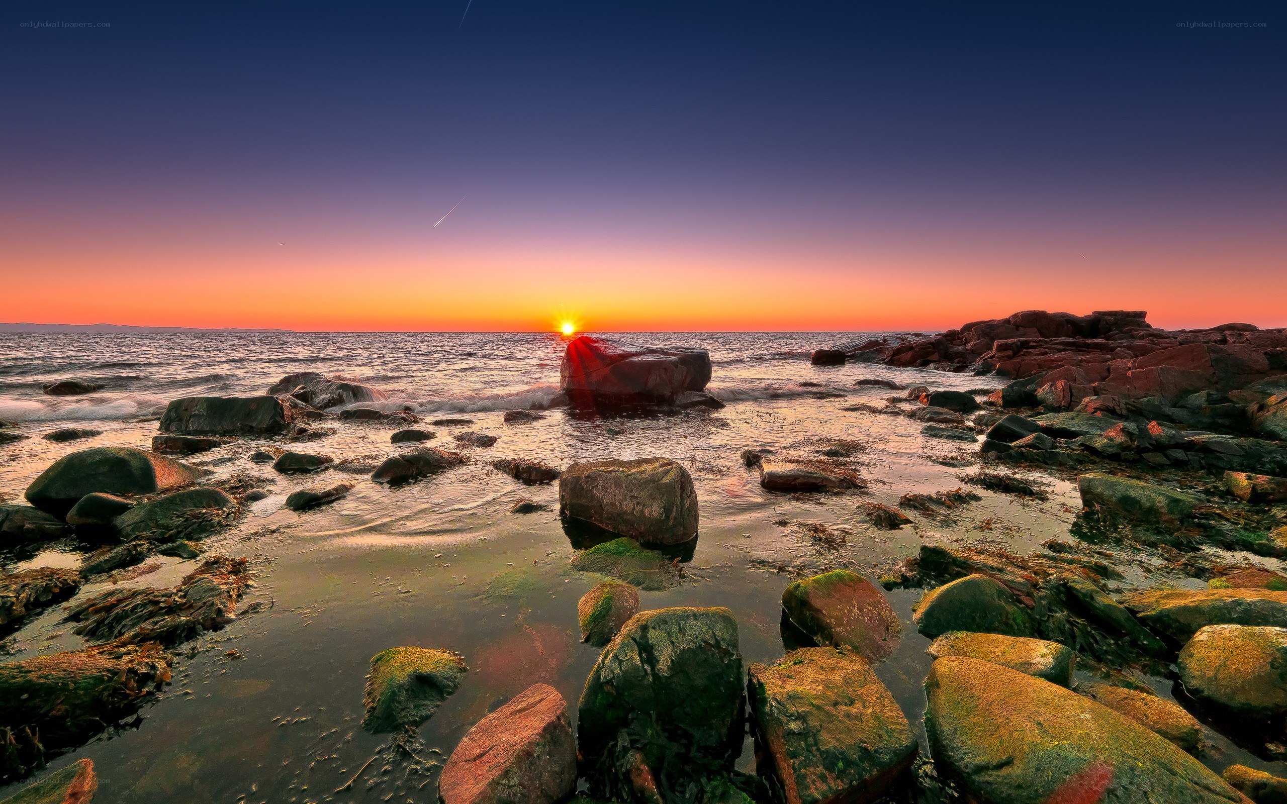 Sunset over rocky shoreline