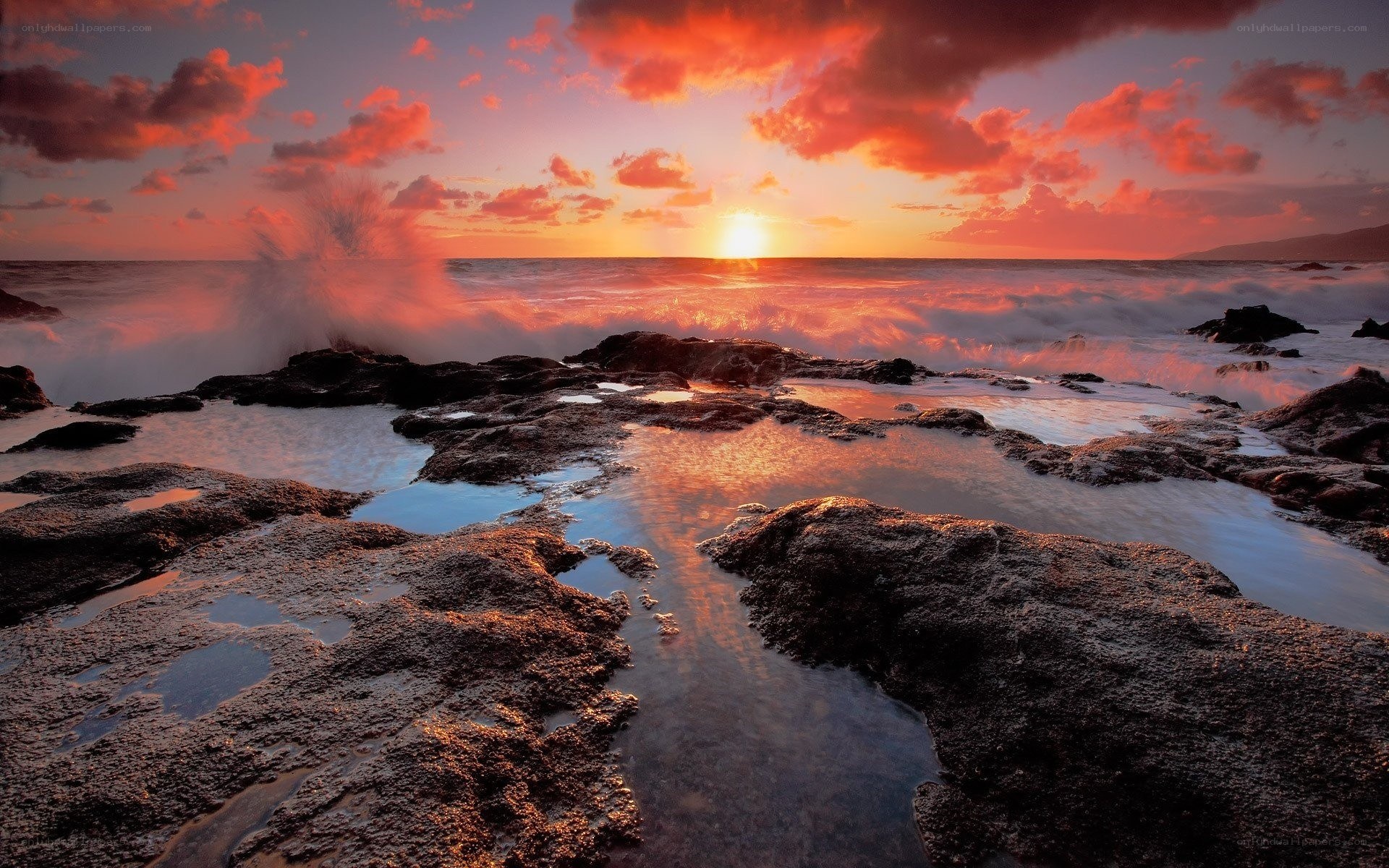 Sunset over rocky shoreline