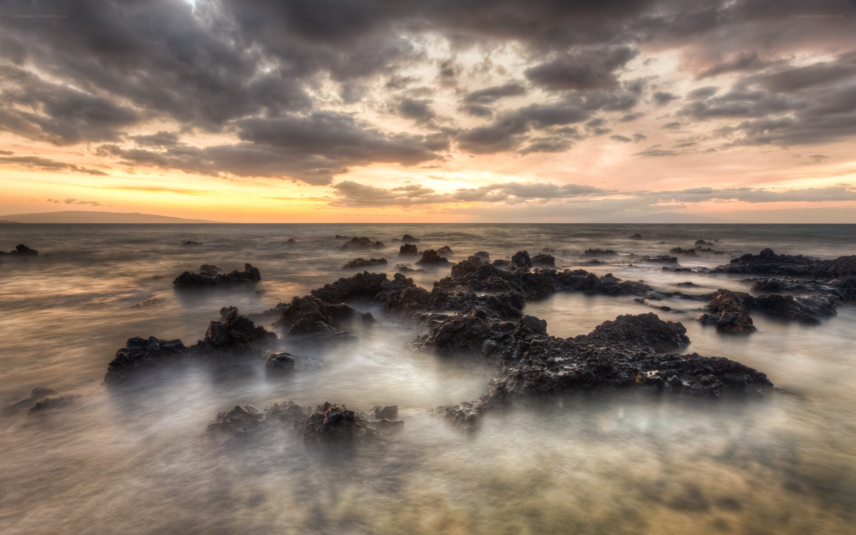 Sunset over rocky shoreline