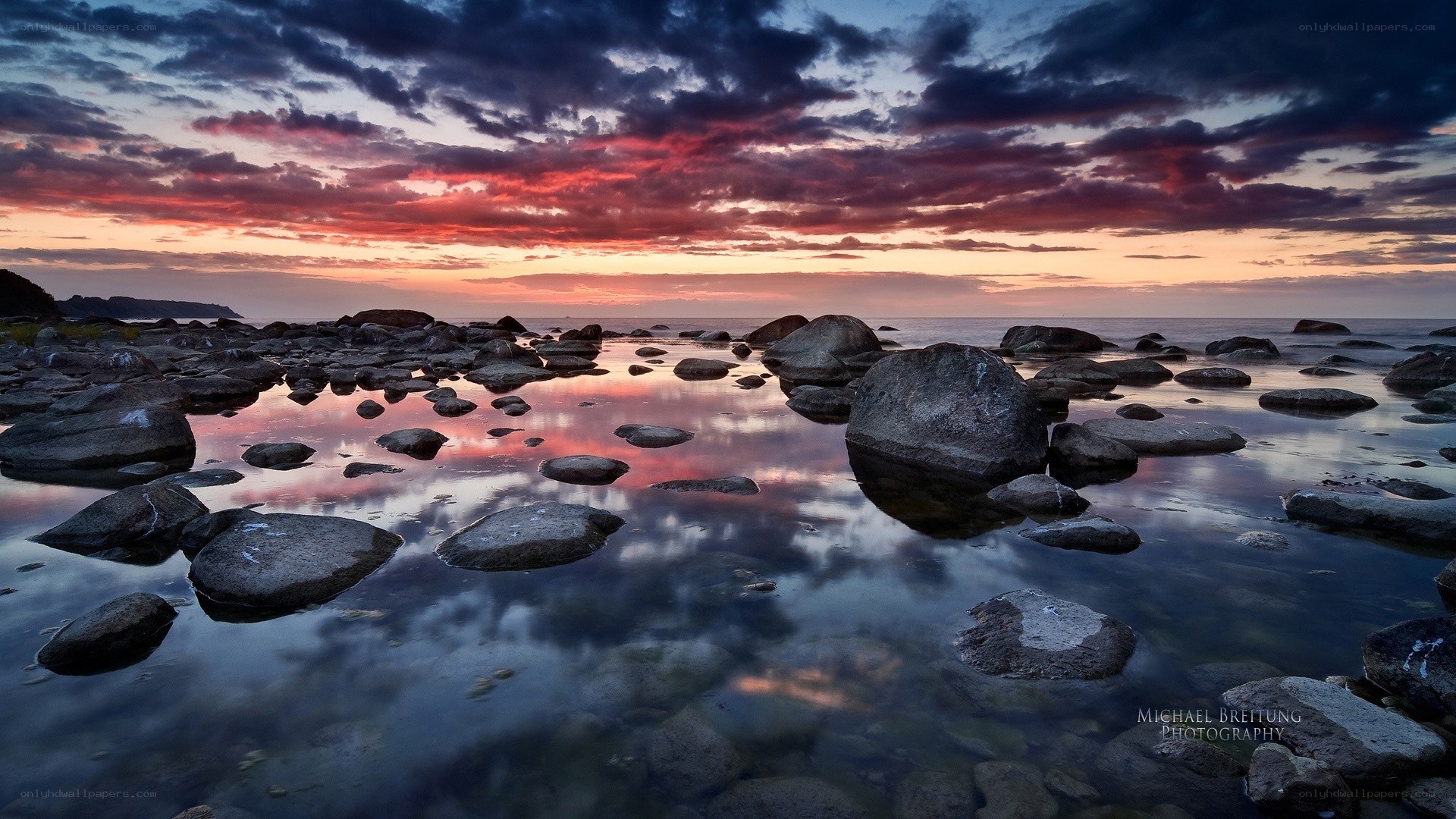 Sunset over rocky shoreline