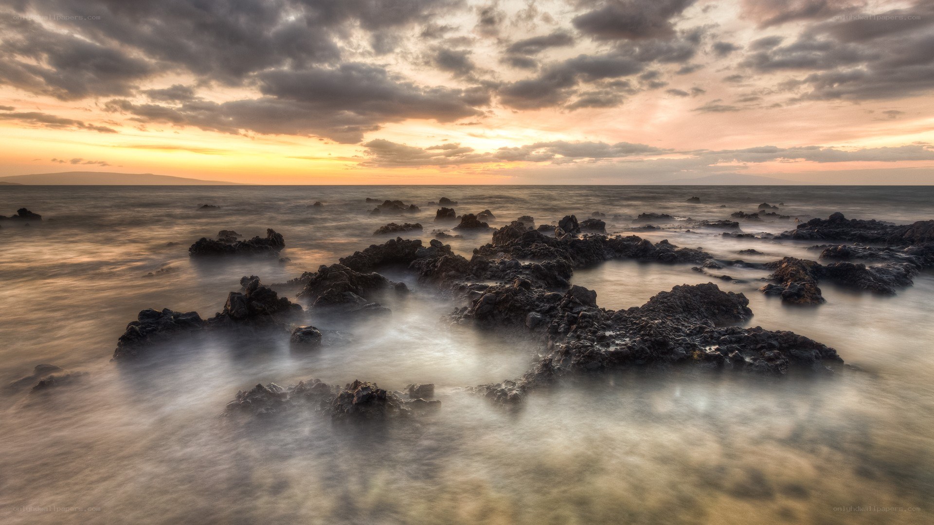 Sunset over rocky shoreline