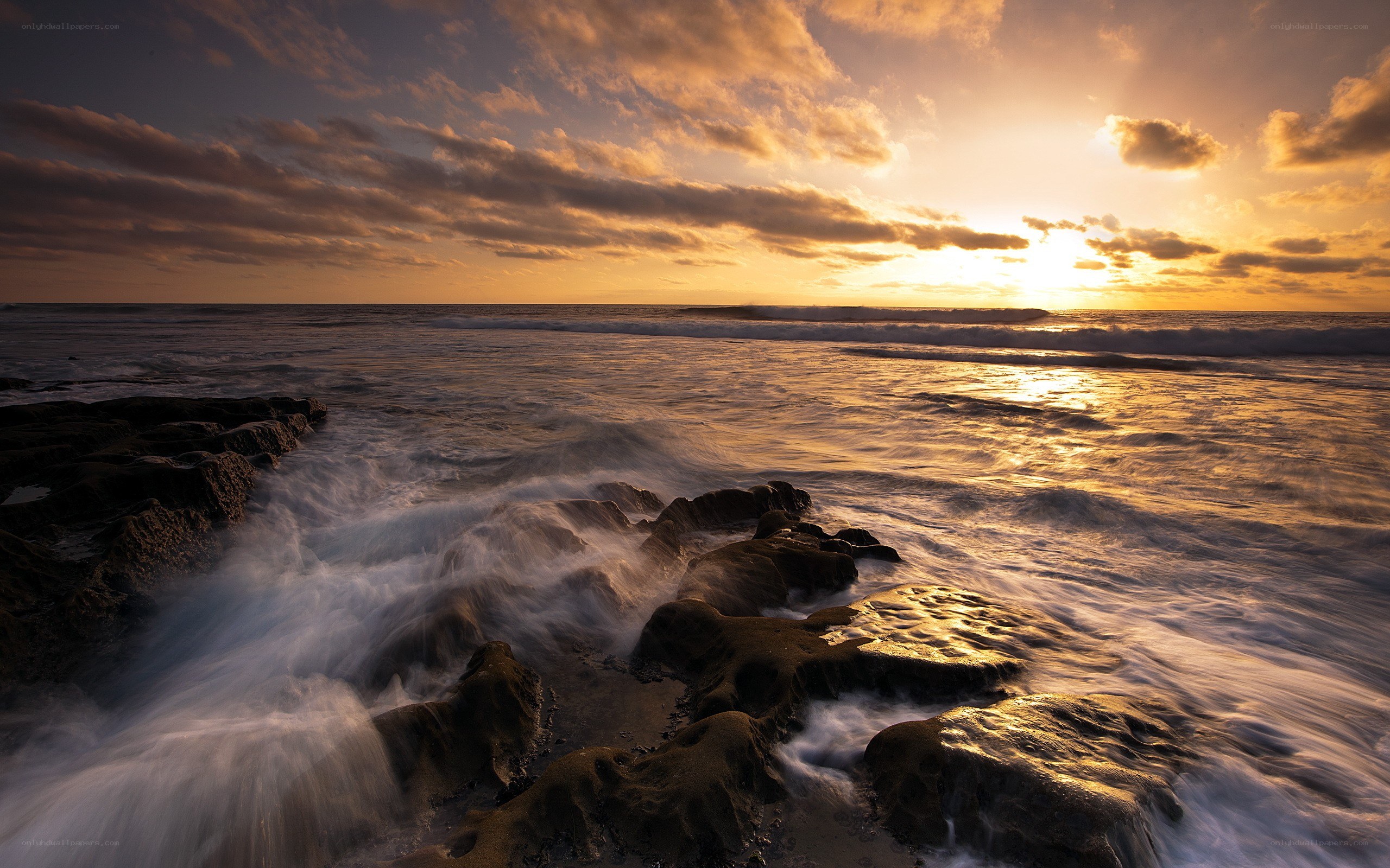 Sunset over rocky shoreline