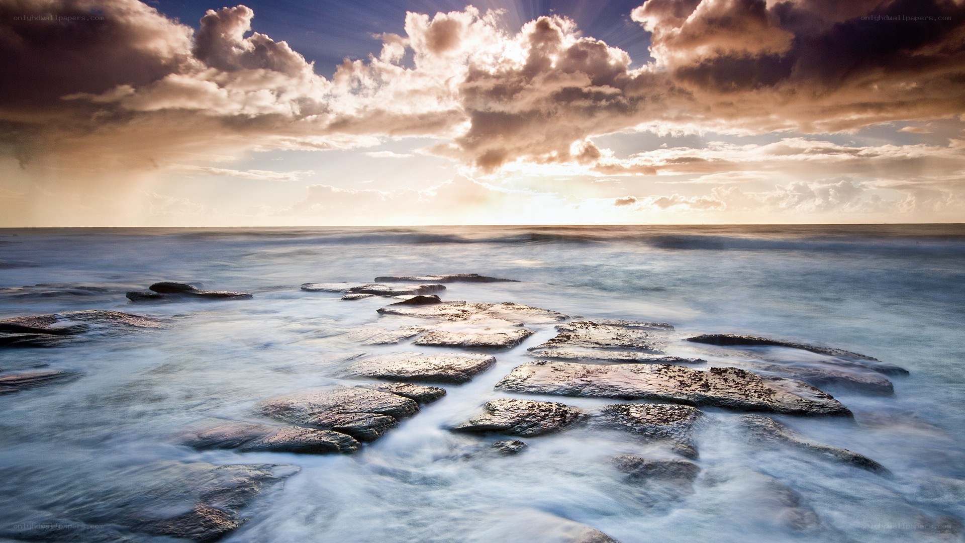 Sunset over rocky shoreline