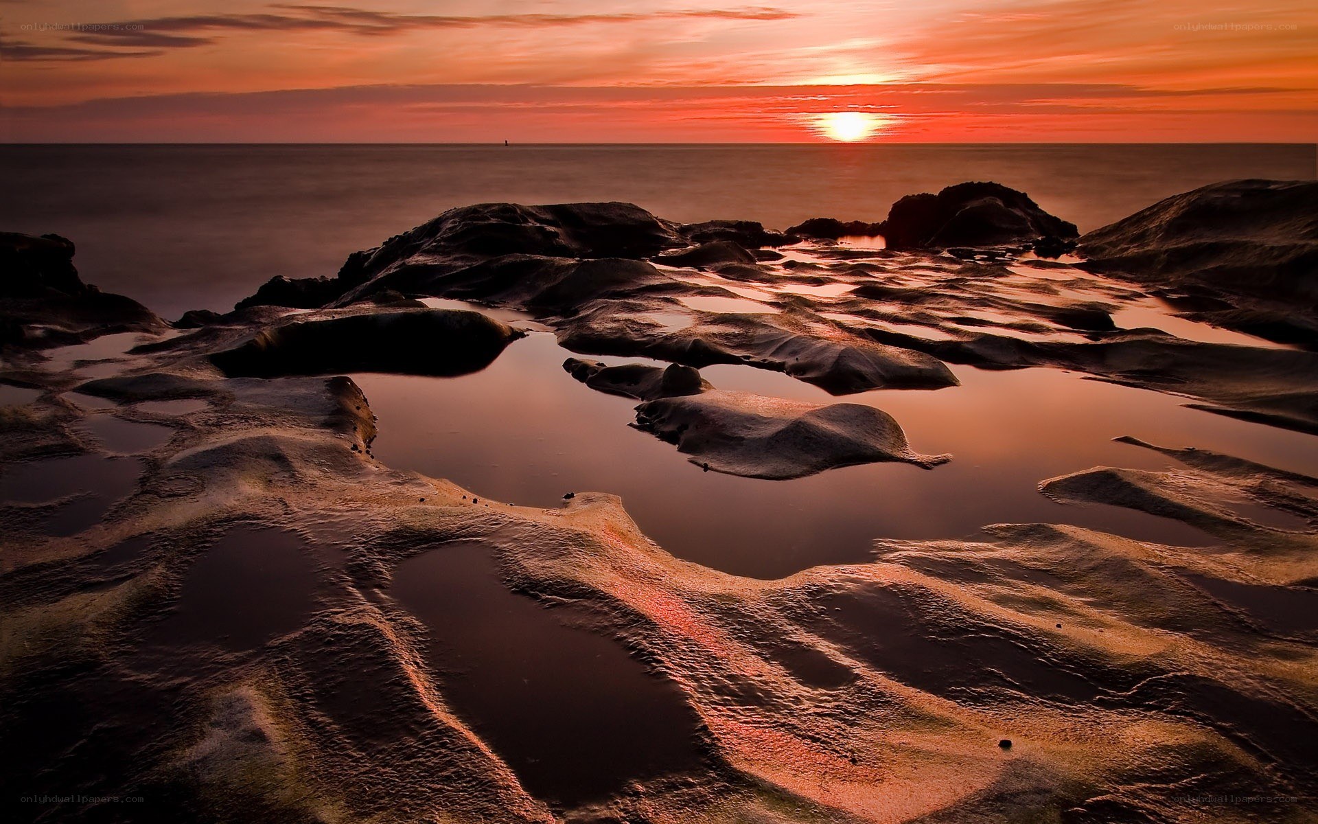 Sunset over rocky shoreline