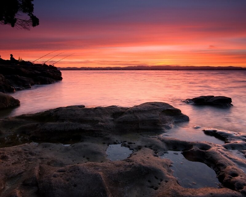 Sunset over rocky shoreline