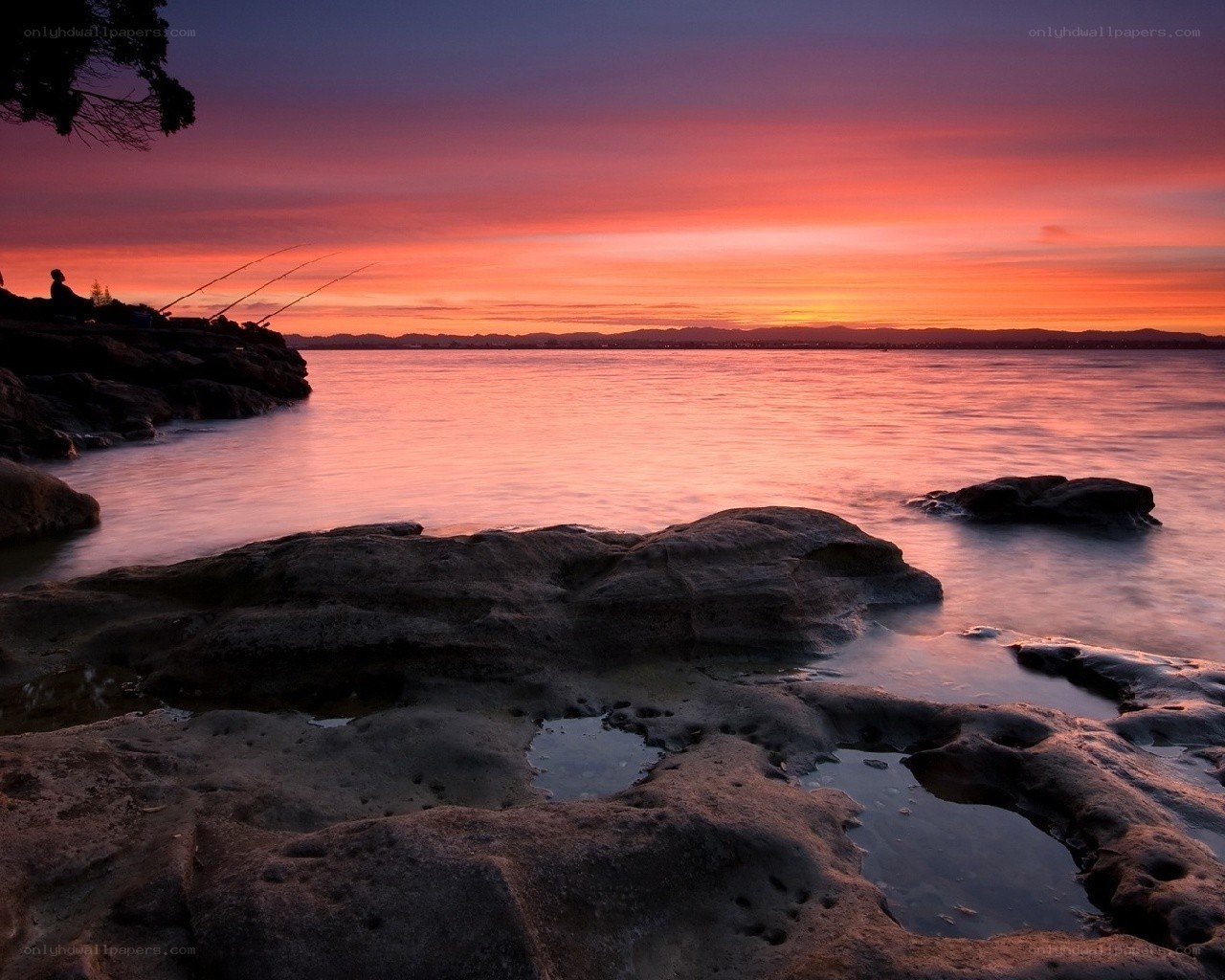 Sunset over rocky shoreline