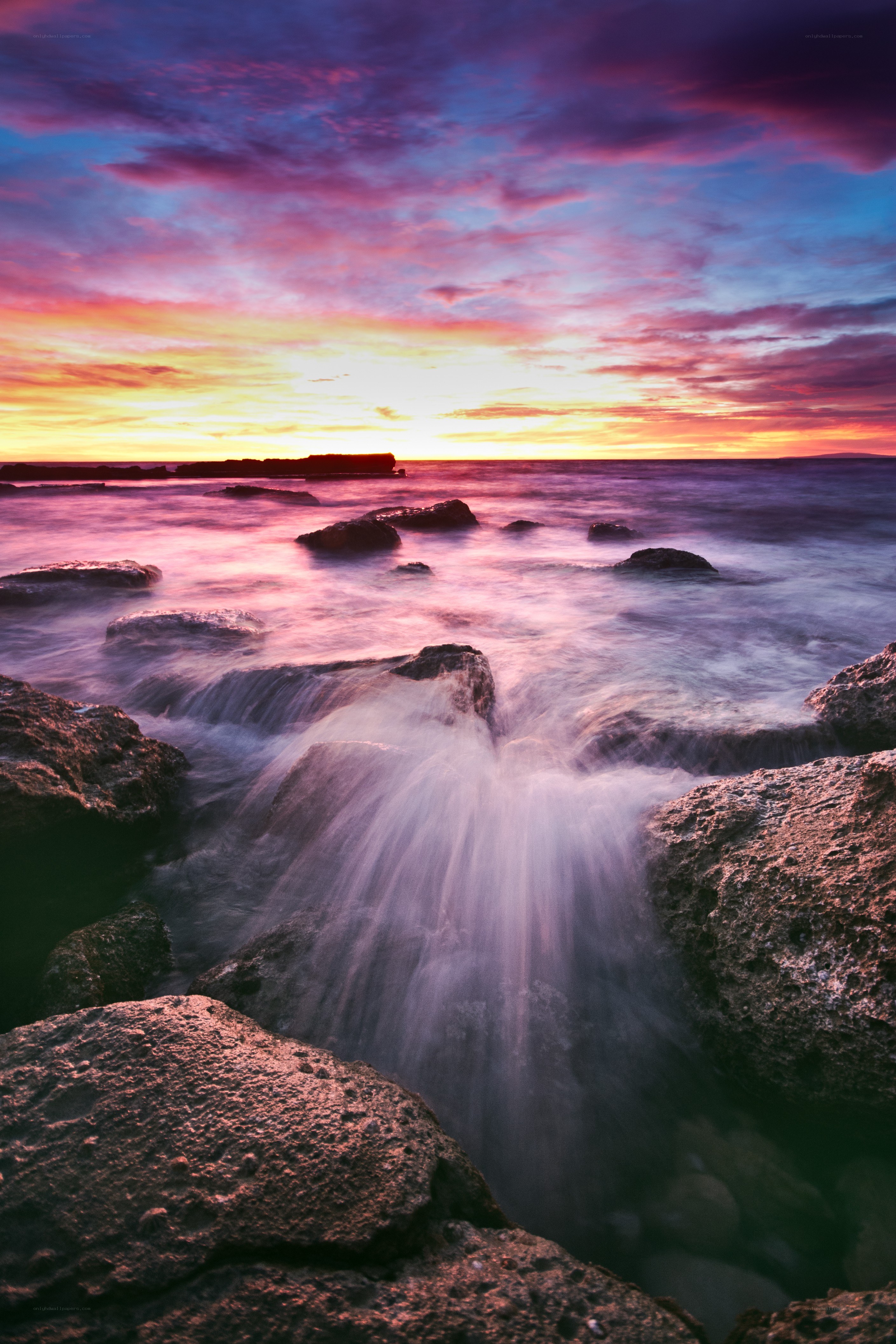 Sunset over rocky shoreline