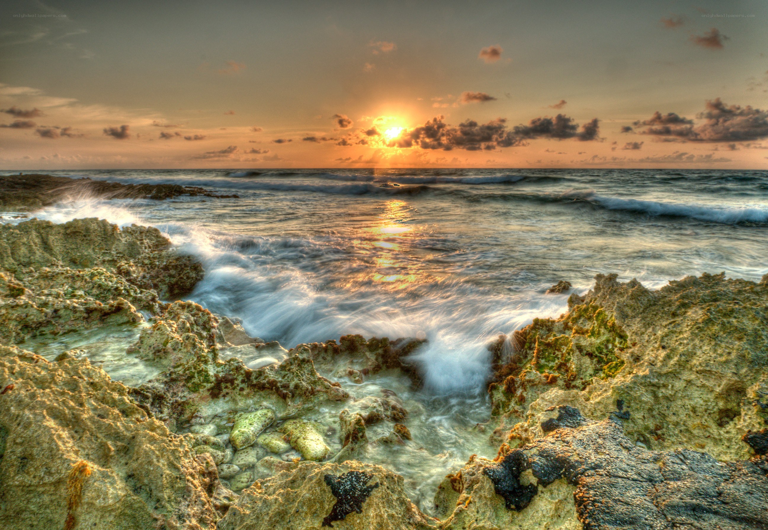 Sunset over rocky shoreline