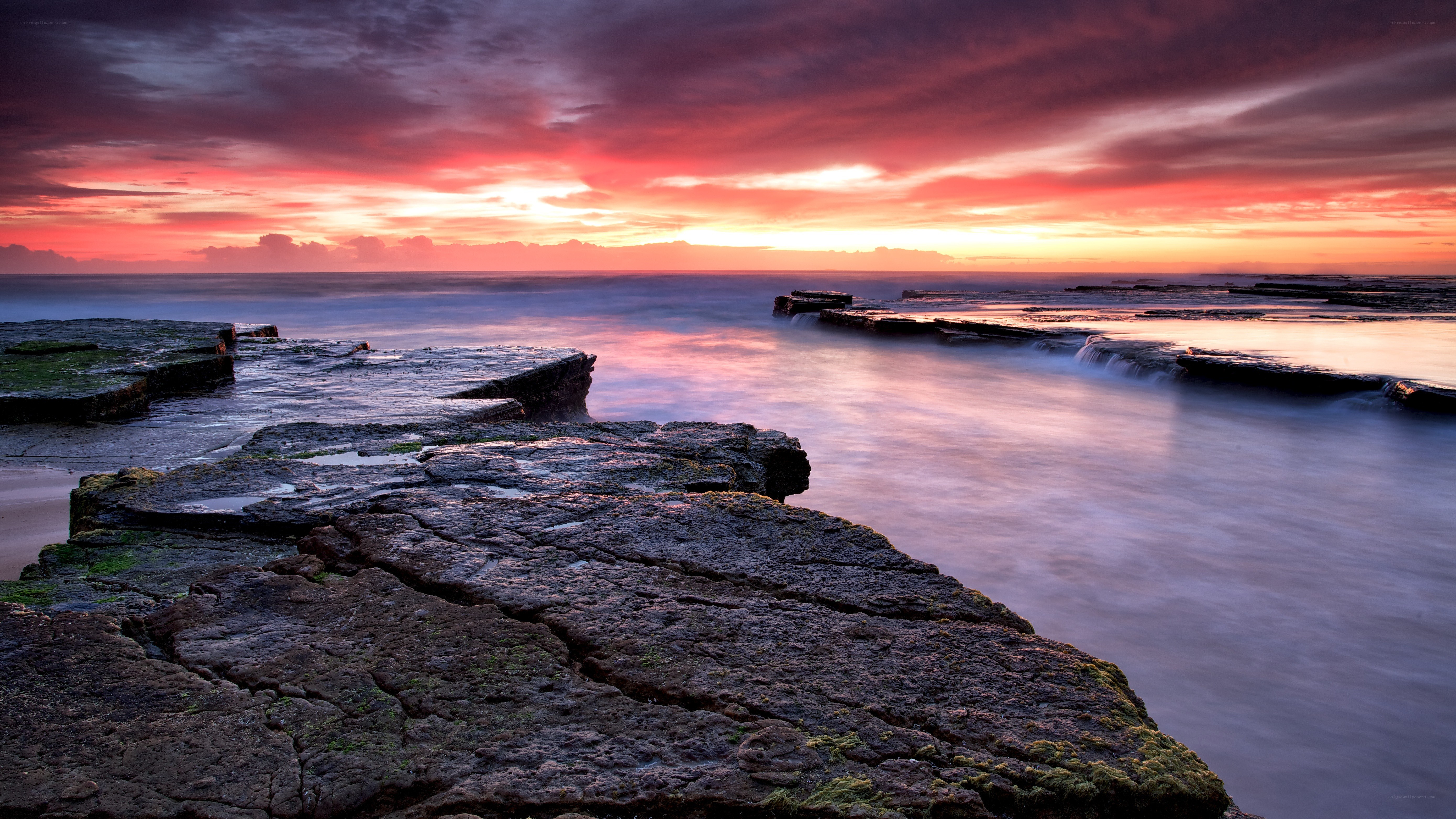 Sunset over rocky shoreline