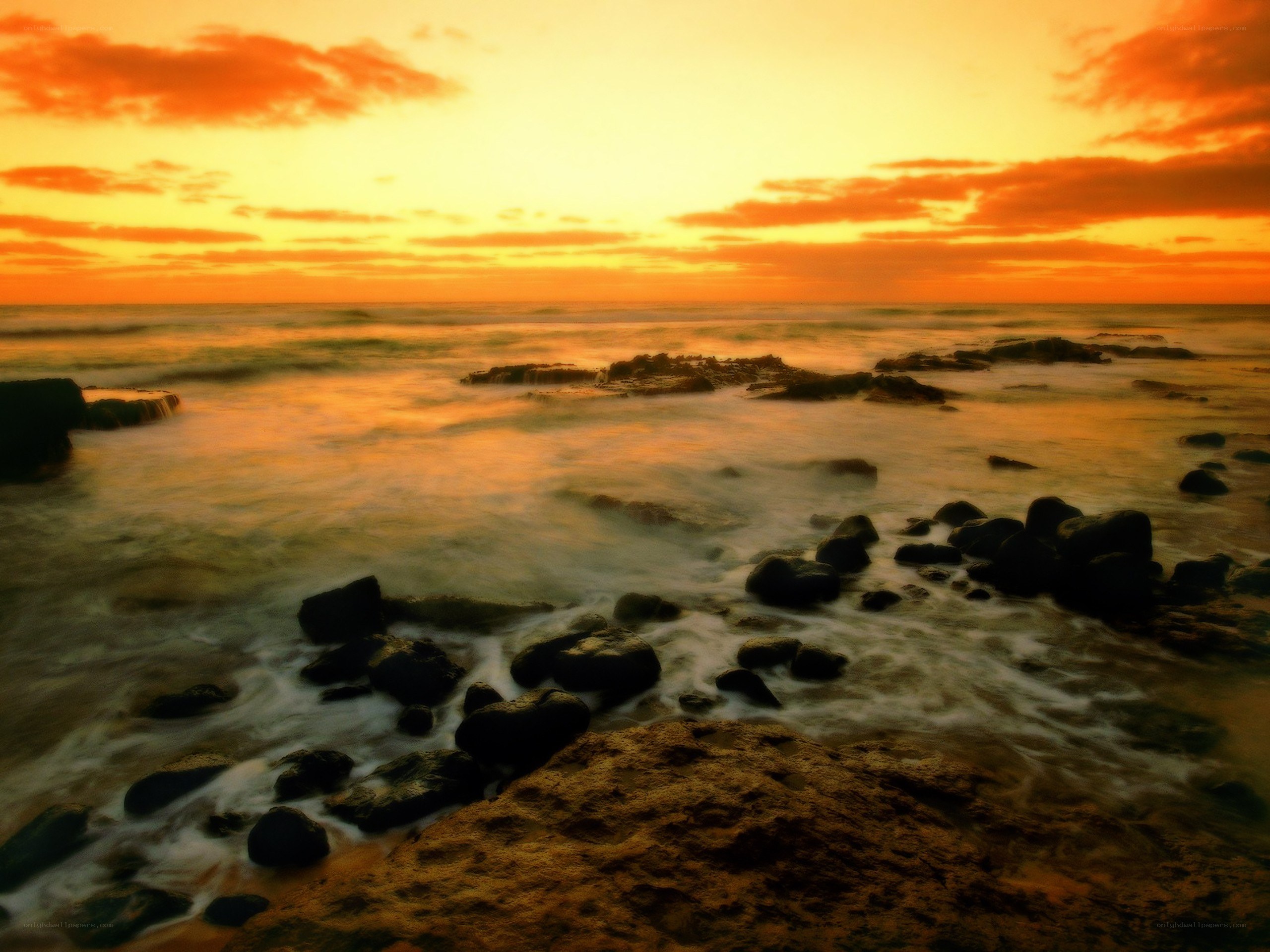 Sunset over rocky shoreline