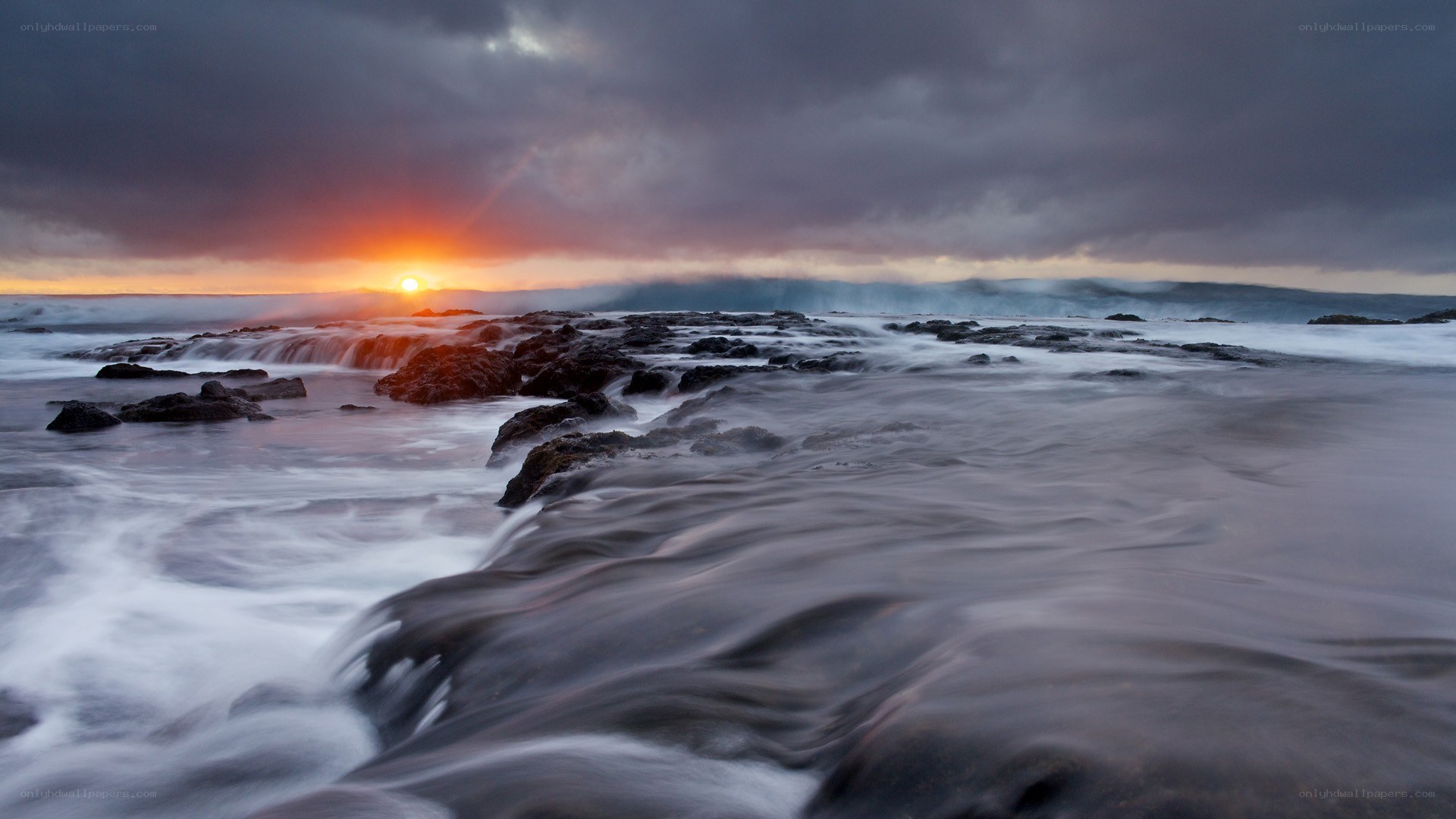 Sunset over rocky shoreline