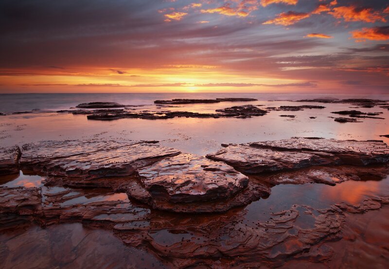Sunset over rocky shoreline