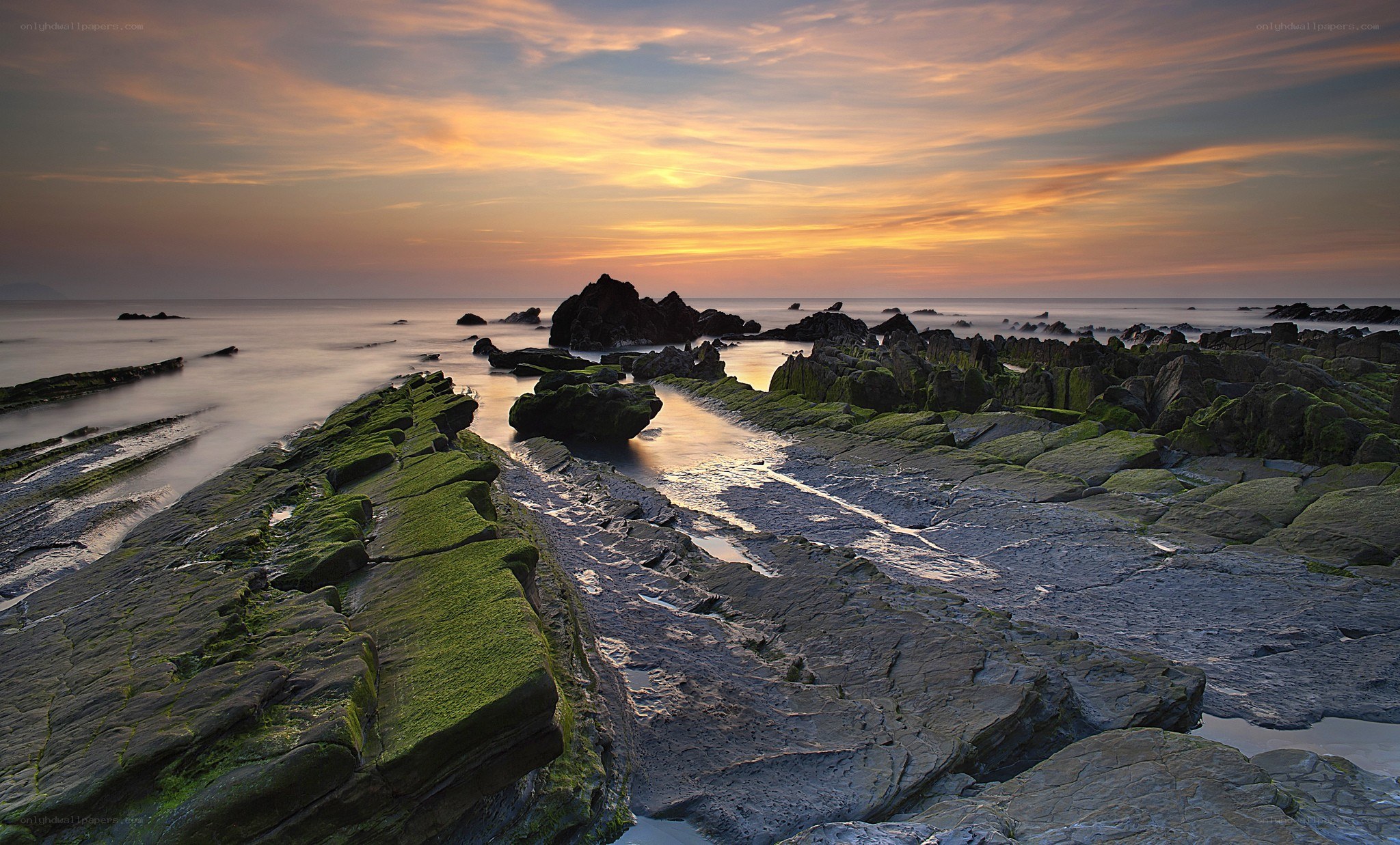 Sunset over rocky shoreline