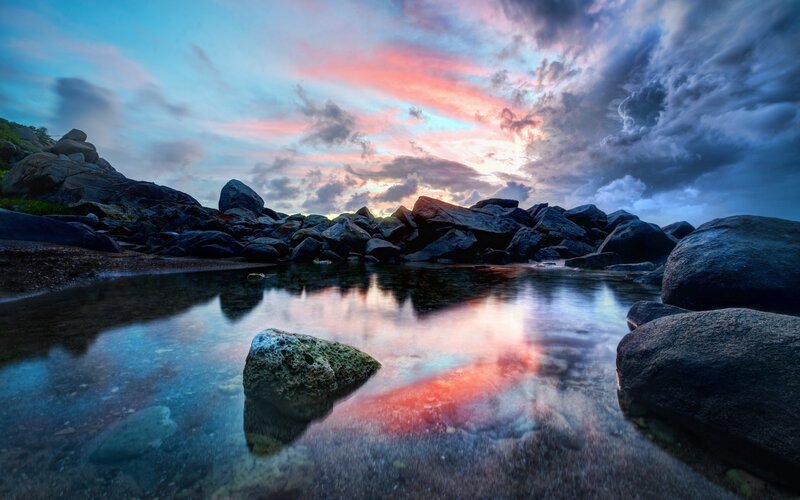 Sunset over rocky shoreline